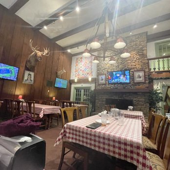 Bullwinkels - a woman sitting at a table in a restaurant - Pizza Near Me - Beech Mountain, North Carolina Bullwinkels - a woman sitting at a table in a restaurant - Pizza Near Me - Beech Mountain, North Carolina