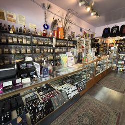 Metaphysical store with crystals, jewelry, tarot, books, and magical supplies.