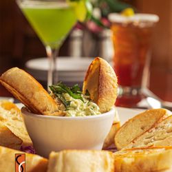 T Paul's Supper Club - Fresh basil artichoke Dip made from scratch when ordered every time.