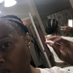 Hair sticking out of braids in the back.
