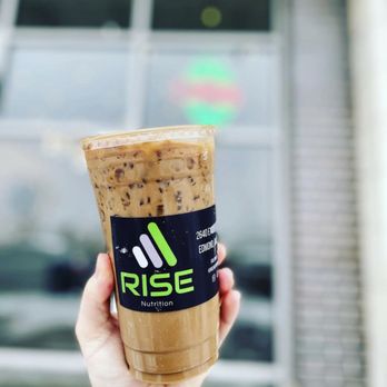 Rise Nutrition - a hand holding a cup of iced coffee - Coffee & Tea Near Me - Edmond, Oklahoma Rise Nutrition - a hand holding a cup of iced coffee - Coffee & Tea Near Me - Edmond, Oklahoma
