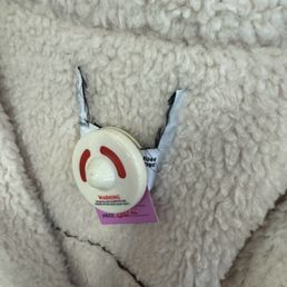 Cut tag on inexpensive jacket to hide brand.