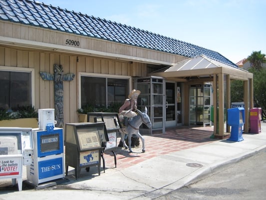 Photo of Wheel Inn Restaurant - Cabazon, CA, US. a miner and his burro outside the entrance to The Wheel Inn