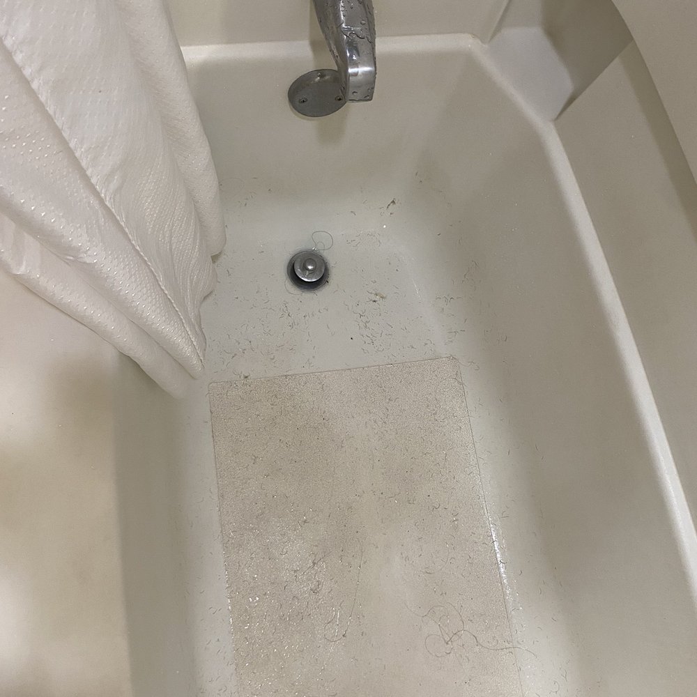 The tub after the water did drain. There was short black hair all over. Def not my hair.