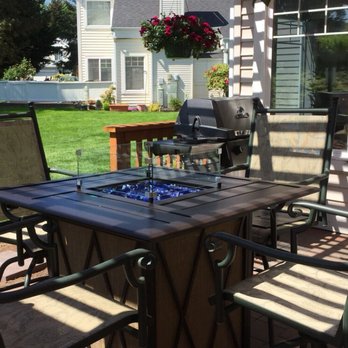 Seattle Grow - a patio with a table and chairs - General Contractors Near Me