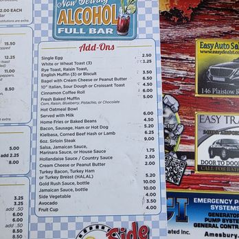 Sunnyside Diner - Breakfast menu, a la carte items - A menu from SunnySide Diner featuring alcohol-related add-ons, breakfast items, and prices, with a blue checkered background and the diner's logo. - Coffee & Tea Near Me - Lawrence, Massachusetts