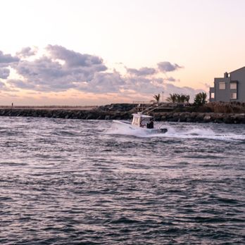 Riverside Cafe - a boat in a body of water - American Near Me - Manasquan, New Jersey Riverside Cafe - a boat in a body of water - American Near Me - Manasquan, New Jersey