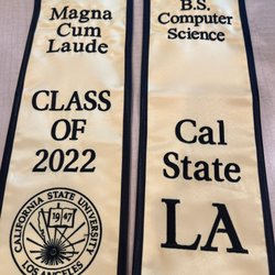 The World of Hats - Two blocks of text embroidered onto sash