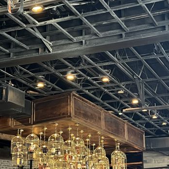 Bosscat Kitchen & Libations - Liquor in cages at the bar - New American Near Me - Houston, Texas