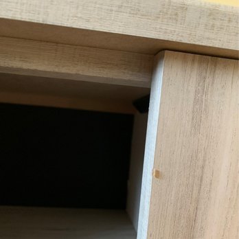 Ashley Store + Outlet - A photo showing a corner of a wooden piece of furniture with a small chip or dent on the edge, taken on September 1, 2020. - Furniture Stores Near Me - Broadview, Illinois