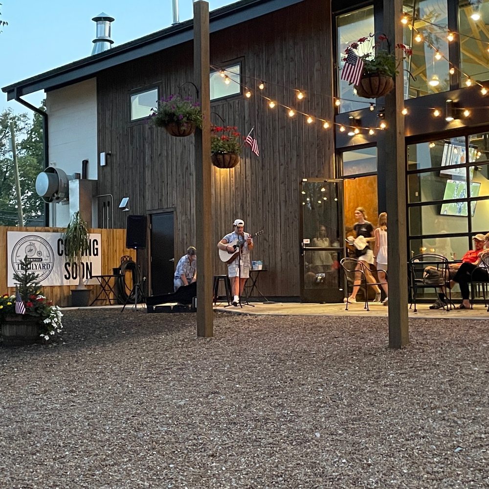 Miamiville Trailyard - a group of people sitting outside a restaurant - American Near Me - Miamiville, Ohio Miamiville Trailyard - a group of people sitting outside a restaurant - American Near Me - Miamiville, Ohio