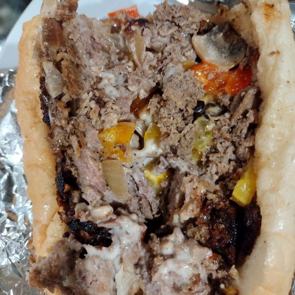 HI Shack - $15 Philly cheese steak.  It tastes better than it looks.  Not as big when compared to the fork in the background - Tacos Near Me - Honolulu, Hawaii