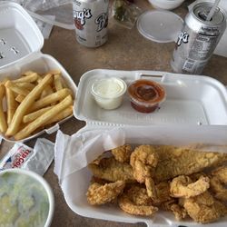 Seafood combo: catfish, shrimp, fries, salad, a drink.