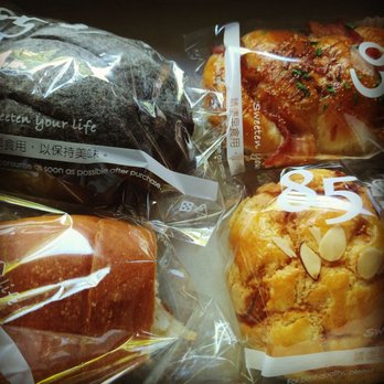 85°C Bakery Cafe-Bellevue - Chocolate mousse stuffed. Cheddar and bacon. Buttery bread roll bottom left. Almond slice cream cheese danish - Bakeries Near Me - Bellevue, Washington