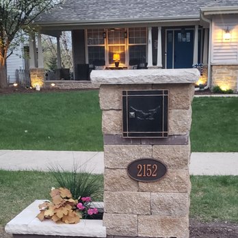 J & P Brothers Landscape - a stone mailbox with a house in the background - Landscaping Near Me