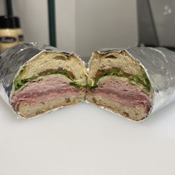 THE ITALIANO. Genoa salami, ham, mortadella, and provolone topped with lettuce, tomato, Italian dressing.