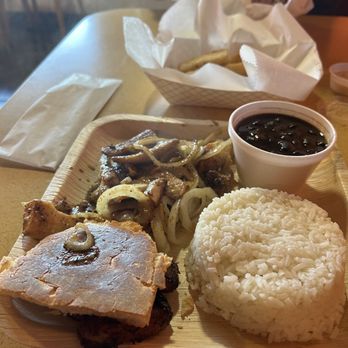 Arroz Con Leche - Mahi mahi cooked with onions, and served with black beans, white rice, plantains, and toasted bread - Cuban Near Me - Holly Hill, Florida Arroz Con Leche - Mahi mahi cooked with onions, and served with black beans, white rice, plantains, and toasted bread - Cuban Near Me - Holly Hill, Florida