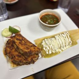 Quesabirria - 2 grilled steam beef tacos with melted cheese. And a Verde Chicken tamale. Quesabirria - 2 grilled steam beef tacos with melted cheese. And a Verde Chicken tamale.