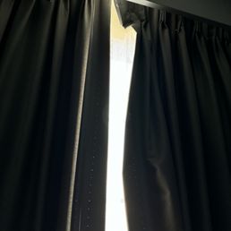 Broken bedroom drapes that let in the light from the parking lot lights. Broken bedroom drapes that let in the light from the parking lot lights.