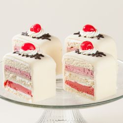 Lutz Cafe & Pastry Shop - Lutz Signature Marzipan Torte. Vanilla cake, raspberry mousse, cake soaked in cherry rum, marzipan frosting
