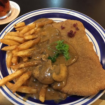 Prost German Restaurant - Iconic Jäger-Schnitzel. A fried Pork loin with mushroom gravy and Pommes Frittes. Also known as French fries. - German Near Me - Aberdeen, Maryland