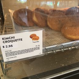 Kimchi Croquette indicated w.black sesame seeds on top