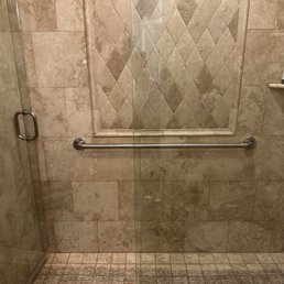Grab bar installed in shower with travertine tile. Grab bar installed in shower with travertine tile.