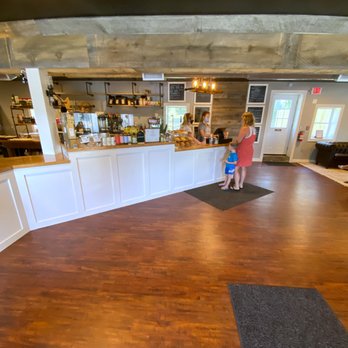 Brew - a woman standing at a bar in a restaurant - Coffee & Tea Near Me - Brentwood, New Hampshire