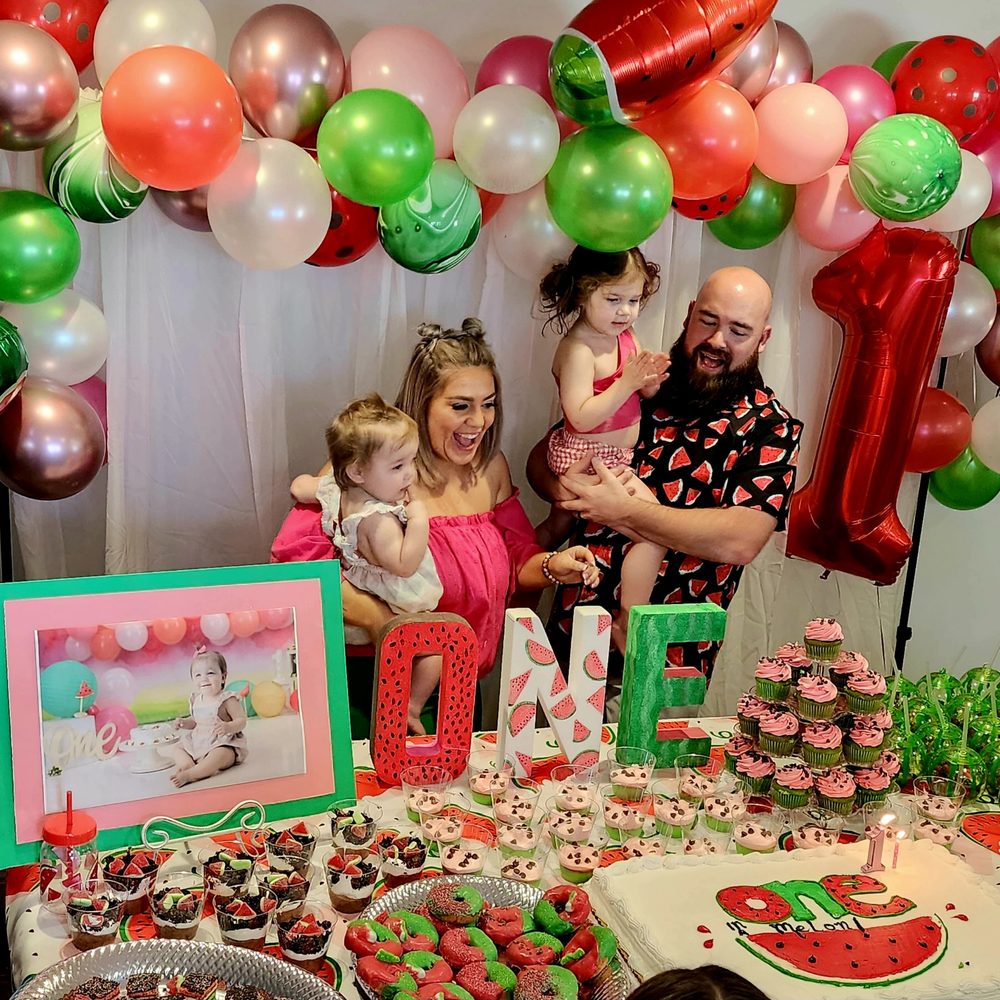 a family at a watermelon themed birthday party a family at a watermelon themed birthday party