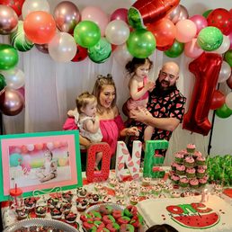 a family at a watermelon themed birthday party