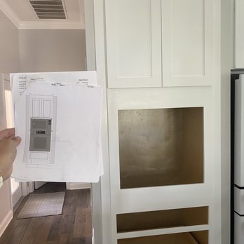 Polo Floors - a person holding a piece of paper in front of a refrigerator - Flooring Near Me - Orlando, Florida Polo Floors - a person holding a piece of paper in front of a refrigerator - Flooring Near Me - Orlando, Florida