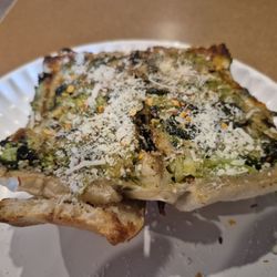 A Touch of Italy - 5-18-25. Spinach and broccoli roll (cut in half) with grated cheese and red pepper flakes sprinkled on. Pretty good.