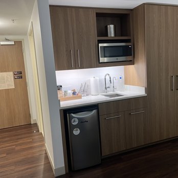 Element Hotel - Great little kitchenette with coffee, tea and sweeteners neatly organized. In the closet is a small safe, ironing board and storage. - Hotels Near Me - Jacksonville Beach, Florida