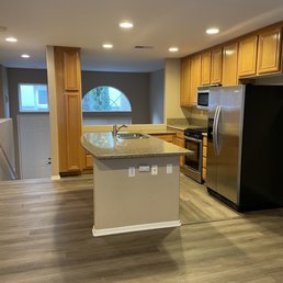a kitchen with a refrigerator and a sink