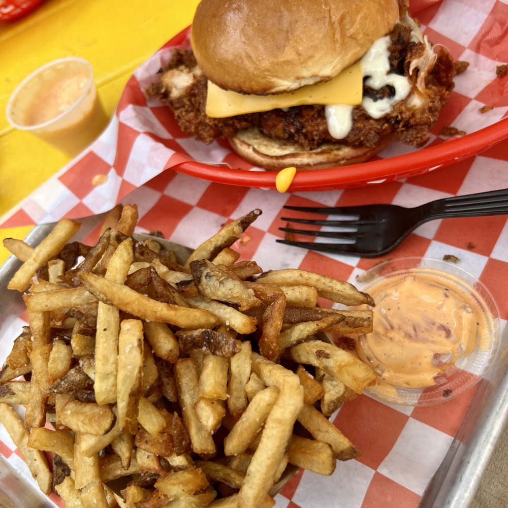 Lucy's - Bacon jam spicy fried chicken sandwich w/ golden fries - American Near Me - Chicago, Illinois
