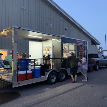 Sweitzer's BBQ - a man and a woman standing in front of a food truck - Smokehouse Near Me - Oakland, Maryland
