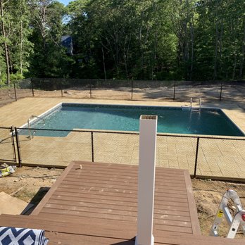 Shoreline Pools - Pool, patio, in ground pool, water, floats, stamped concrete, colored concrete, fence - Pool & Hot Tub Service Near Me - South Dennis, Massachusetts Shoreline Pools - Pool, patio, in ground pool, water, floats, stamped concrete, colored concrete, fence - Pool & Hot Tub Service Near Me - South Dennis, Massachusetts