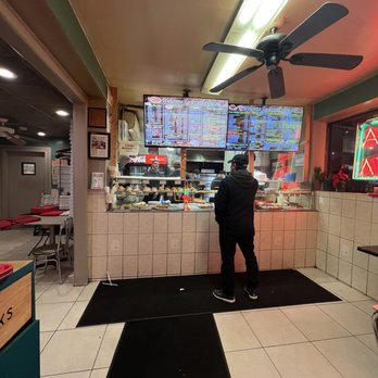 Frank's Pizzeria - a man standing at the counter - Pizza Near Me - Bronx, New York