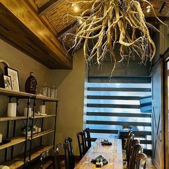 Texas Spice - a dining room with a wooden table and chairs - New American Near Me - Dallas, Texas