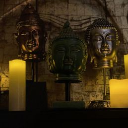 Candles and Buddhist head sculptures to set the mood Candles and Buddhist head sculptures to set the mood