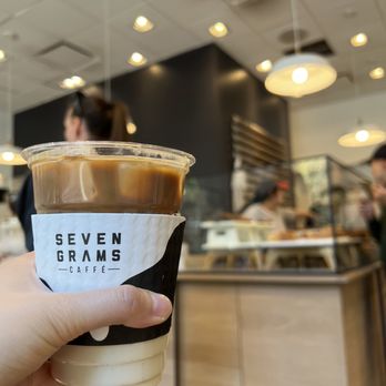 Seven Grams Caffe - a hand holding a cup of coffee - Coffee & Tea Near Me - New York, New York Seven Grams Caffe - a hand holding a cup of coffee - Coffee & Tea Near Me - New York, New York
