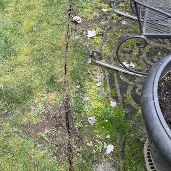 Amazing Landscape Services - This is their idea of edging. They just left the overgrowth grass on the patio. - Landscaping Near Me - Edgewood, Washington