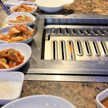 Handoo Korean Bbq - Banchan and sauces , grill is heating - Barbeque Near Me - San Diego, California