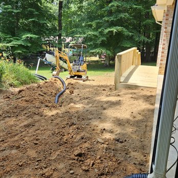 RichCo Excavating - Laying down spout drain tile - Excavation Services Near Me