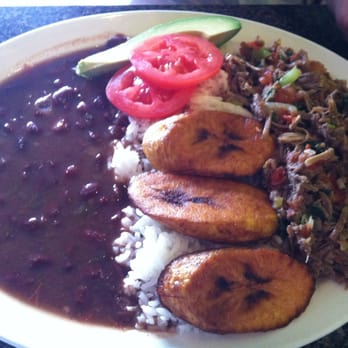 El Portal Cafe - Ropa Vieja: shredded beef, plantains, rice, beans, tomatoes and a slice of an avocado. - Bakeries Near Me - Carrollton, Texas El Portal Cafe - Ropa Vieja: shredded beef, plantains, rice, beans, tomatoes and a slice of an avocado. - Bakeries Near Me - Carrollton, Texas