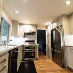 North Seattle Handyman - Fully remodeled kitchen room with custom cabinets, sink , tile backsplash and counter top by North Seattle Handyman