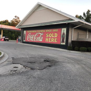Fleming Shortcut - a coca cola sign on the side of a building - Convenience Stores Near Me