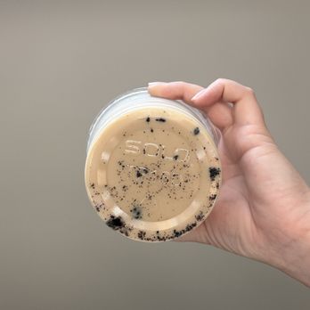 Paper or Plastik Cafe - Coffee grounds in iced vanilla latte - New American Near Me - Los Angeles, California