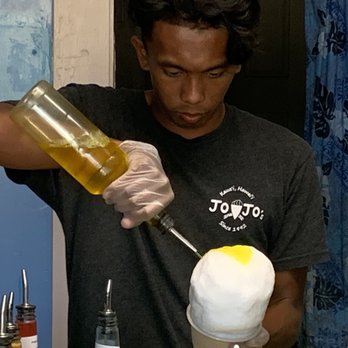 Jojo's Shave Ice - pouring the banana syrup for Wyatt's KEIKI DELIGHT - Shaved Ice Near Me - Kapaa, Hawaii Jojo's Shave Ice - pouring the banana syrup for Wyatt's KEIKI DELIGHT - Shaved Ice Near Me - Kapaa, Hawaii