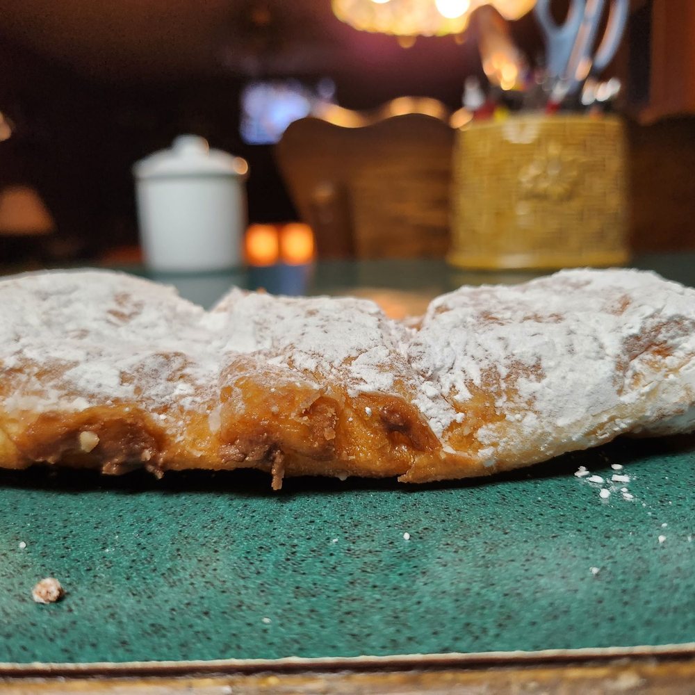 Madsen Donuts - a donut with powdered sugar and powdered sugar - Donuts Near Me - Geneva, Ohio